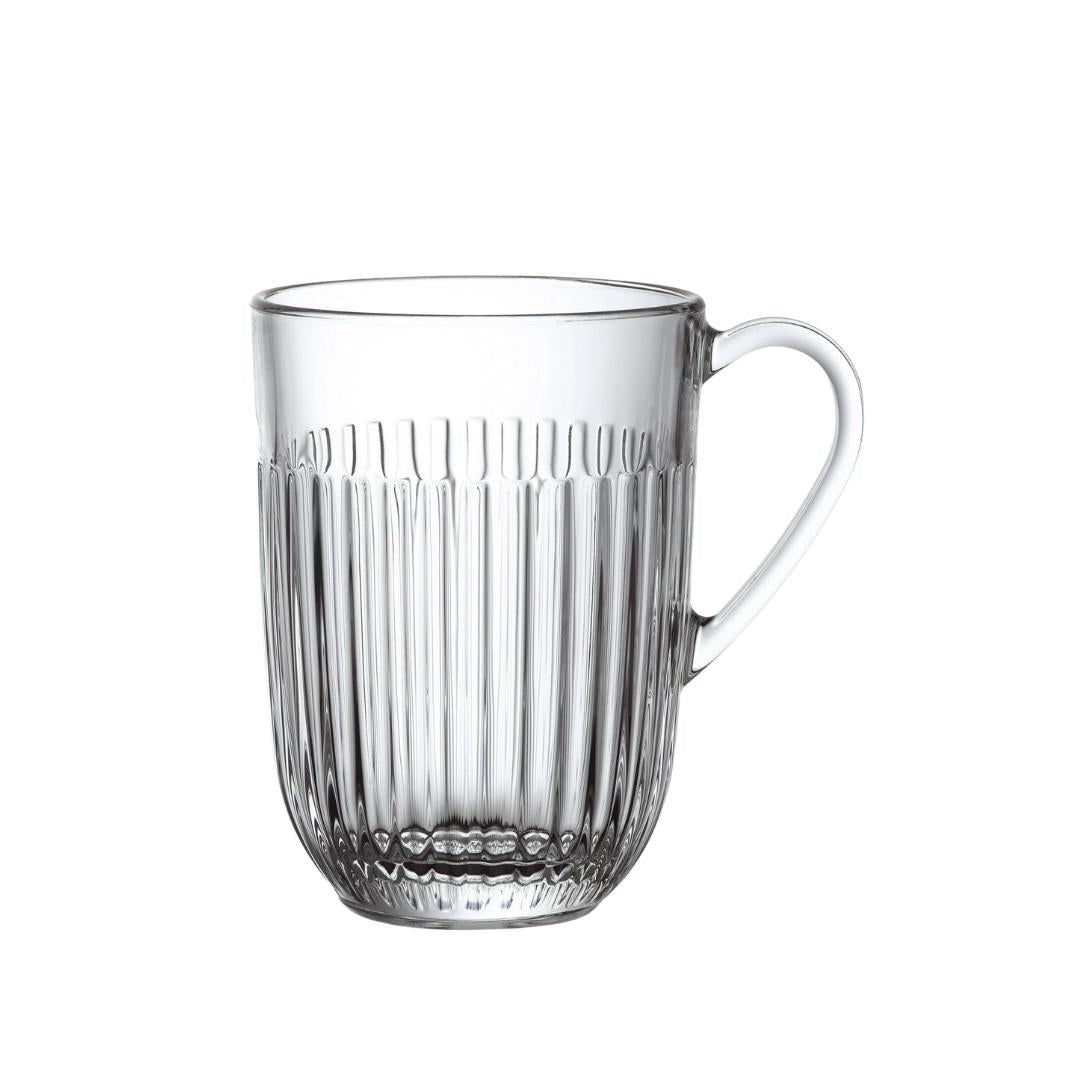The image features a RIBBED MUG by LA ROCHERE, which showcases embossed vertical lines along its clear glass body. The mug includes a handle on the right side and has a slightly wider top opening. With its gently rounded base, this mug exudes elegance while being both microwave and dishwasher safe.
