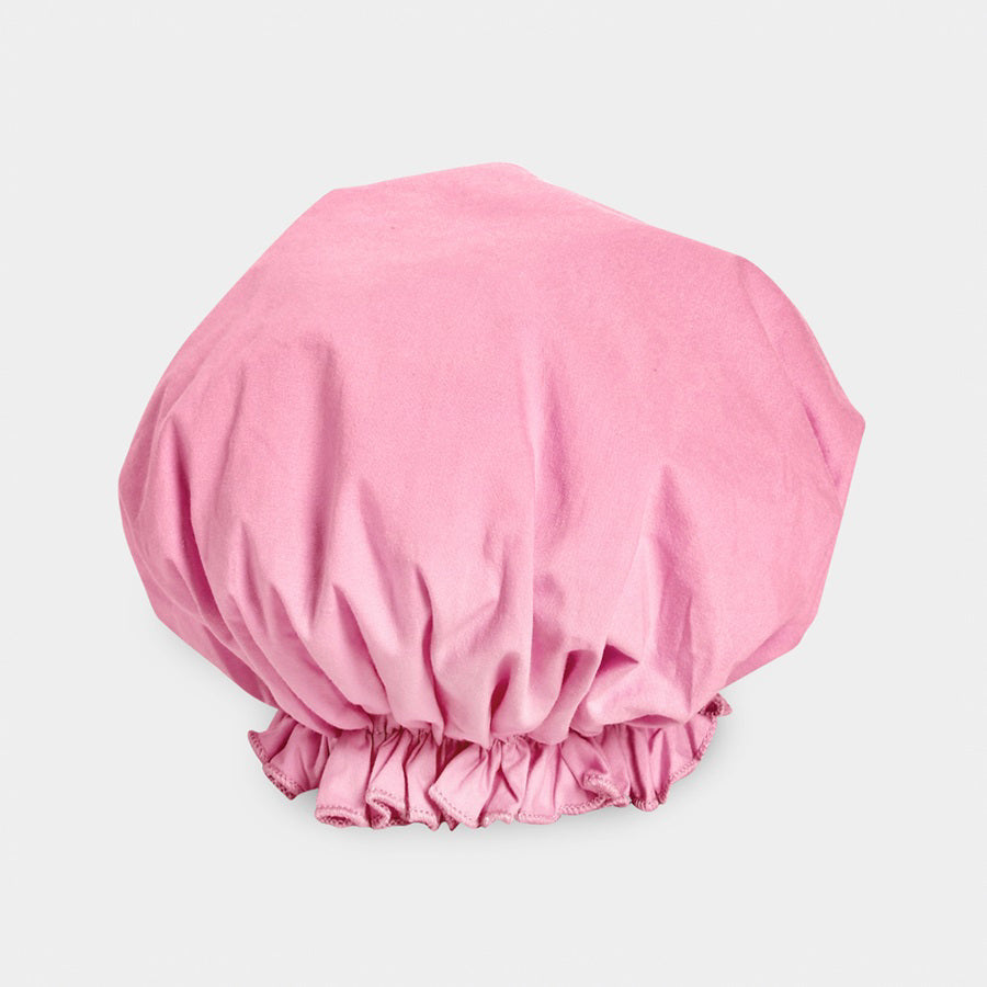 Introducing the BOUFFANT SHOWER CAP from BATH ACCESSORIES COMPANY! This stylish shower cap showcases a vibrant design of colorful macarons in shades of pink, purple, yellow, and brown against a lively green background. It features a waterproof inner layer to keep your hair dry and an elasticated bottom for a secure and comfortable fit.
