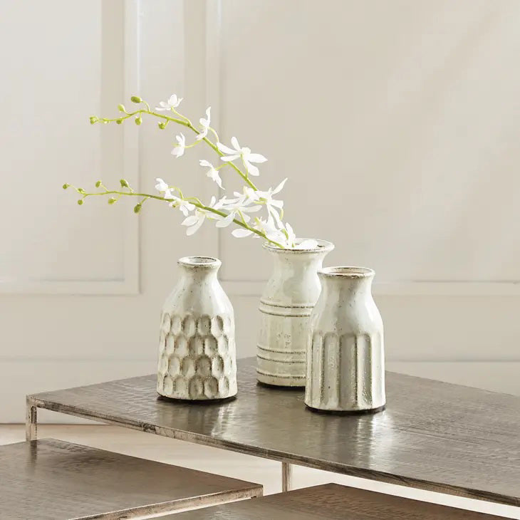 The NAPA HOME AND GARDEN - ORCHID STEM features a long green stem with delicate white artificial blossoms, branching into three elegant sections. Perfect for enhancing your home decor with its realistic design against a neutral background.