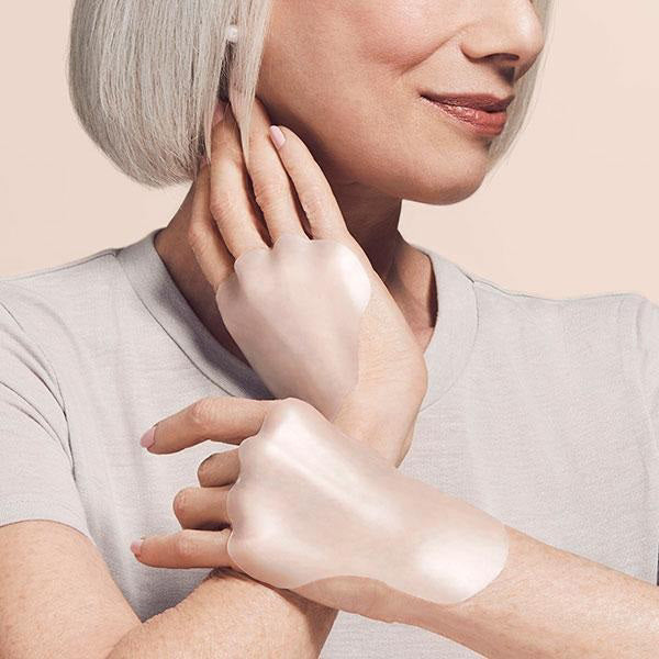 An image showing a pack of SiO Beauty&#39;s SiO Handlift Reusable Wrinkle-Smoothing Patches. The left side displays the pink packaging with the product name &quot;SIO HANDLIFT&quot; and a description. The right side features one of the translucent, medical-grade silicone patches in its packaging, designed for effective hand wrinkle treatment.