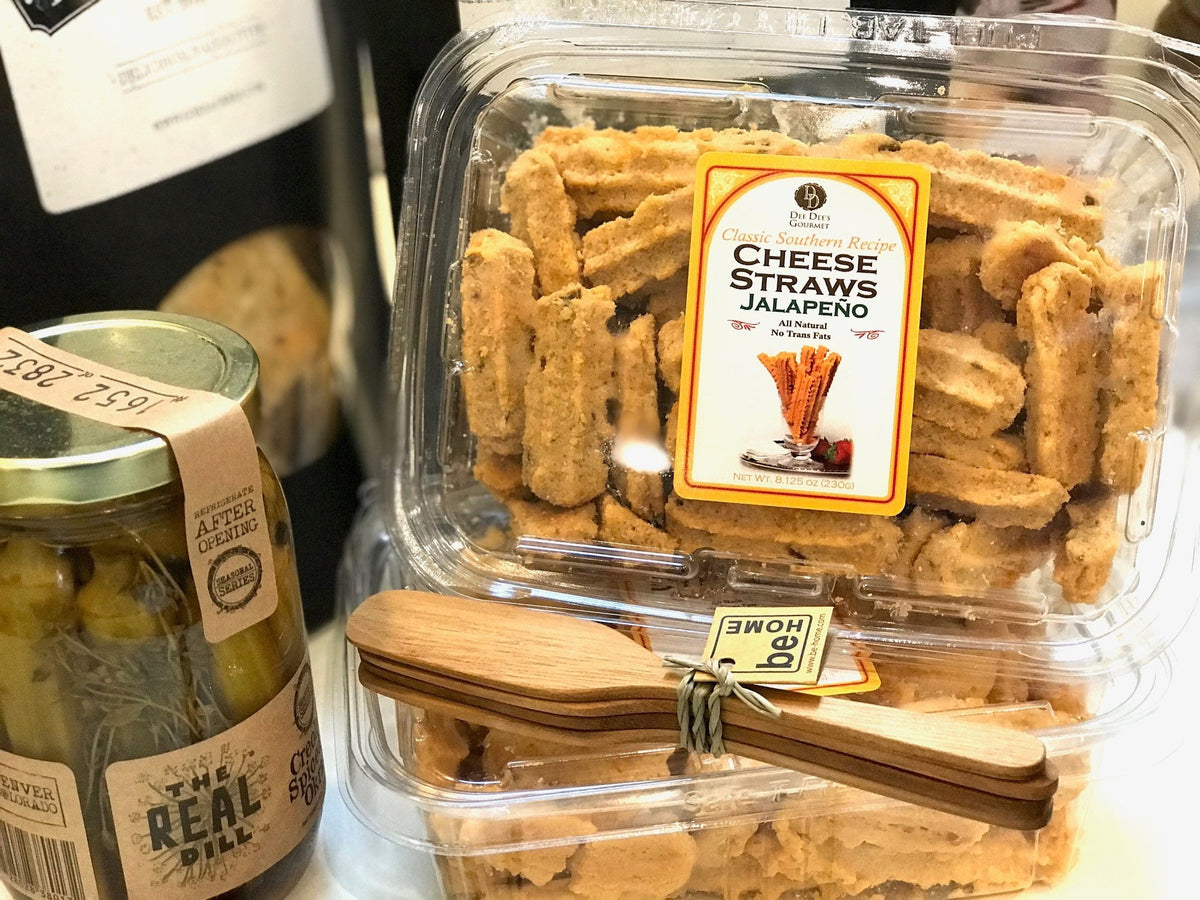 A clear plastic container of DEE DEE'S GOURMET - CHEESE STRAWS from DEE DEE'S GOURMET, with a lid label showing the cheese straws beside a cheddar block and reading "Classic Southern Recipe Cheese Straws Cheddar.