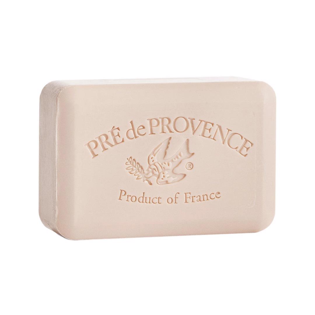A rectangular beige bar of quad-milled French soap from European Soaps, LLC, embossed with &quot;Pré de Provence&quot; and a bird holding a branch, along with the text &quot;Product of France&quot; below it. The shea butter enriched COCONUT BAR SOAP 150G has smooth edges and a clean appearance.
