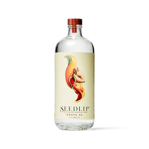A glass bottle of SEEDLIP - GROVE 42 NON ALCOHOLIC SPIRITS from SEEDLIP DRINKS. The label, marked "Grove 42 Citrus," features a colorful, artistic depiction of citrus fruits and leaves. This citrus blend is sealed with a red cap, showcasing the clear liquid inside—a perfect choice among non-alcoholic options.