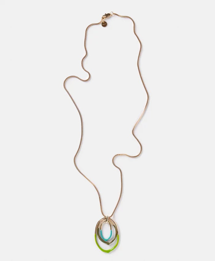 The DIP DYED NECKLACE by MOMONI is a long gold necklace featuring a delicate Venetian chain and interlocking oval pendants at the center. Made in Italy, the pendants showcase a layered look with gold, white, and coral colors. The necklace is displayed flat on a white background.