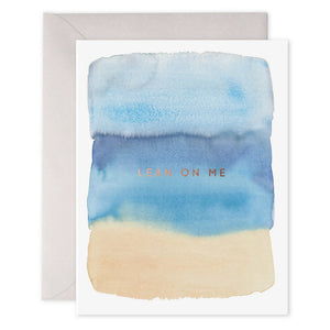 The E. FRANCES PAPER - LEAN ON ME CARD showcases abstract watercolor in blue and beige bands with "LEAN ON ME" highlighted in gold foil at the center, accompanied by a white envelope.