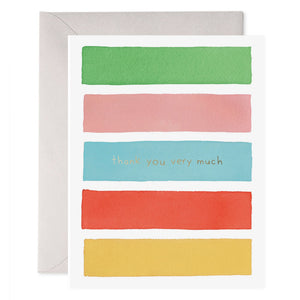 The E. FRANCES PAPER - COLOR BARS THANK YOU CARD showcases five horizontal watercolor stripes in green, pink, blue, red, and yellow. The words "thank you very much" shimmer with gold foil on the blue stripe and come elegantly placed on an envelope.