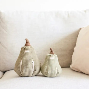Introducing the LAMBWOLF COLLECTIVE Butternut Dog Toy (S) by LAMBWOLF COLLECTIVE—a soft and plush pear-shaped toy crafted with a textured, ribbed fabric. This adorable greyish-brown pear features a dark brown stem at the top and a small fabric label on its side. Designed for both decoration and play, its hidden treat pockets make it irresistibly cute and cozy for your furry friend.