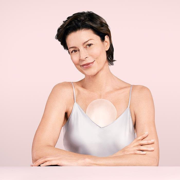 An image showcasing the SIO ChestLift reusable wrinkle-smoothing patches by SIO Beauty. The product features pink packaging labeled &quot;Chest: SiO ChestLift&quot; on the left, and an adhesive patch in a figure-eight shape made of medical-grade silicone placed on a clear sheet on the right. Ideal for effective treatment of chest wrinkles.