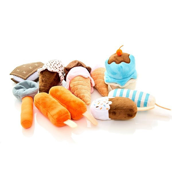 The ICE CREAM PLAY FOOD SET by WONDER AND WISE ASWEETS features a delightful assortment of plush toys shaped like various desserts, such as ice cream cones, popsicles, a cupcake, and even a carrot. These vibrant toys in shades of orange, brown, blue, pink, and white are perfect for endless scooper fun and are beautifully arranged on a white surface.