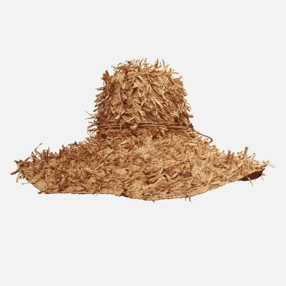 The SUMMERTIME HAT by SANS ARCIDET features a wide brim and a rustic, shaggy texture. Its loosely woven design offers a casual, bohemian vibe, with fringed crown and brim that enhance its rough, natural look. Perfect as a beach accessory, this adjustable hat stands out brilliantly against the plain white background.