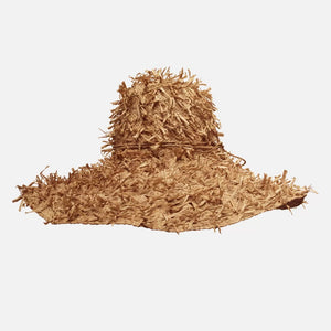 The SUMMERTIME HAT by SANS ARCIDET features a wide brim and a rustic, shaggy texture. Its loosely woven design offers a casual, bohemian vibe, with fringed crown and brim that enhance its rough, natural look. Perfect as a beach accessory, this adjustable hat stands out brilliantly against the plain white background.