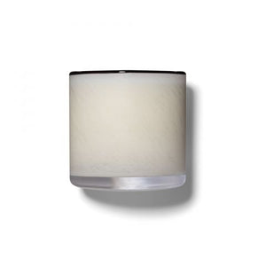 The LAFCO - CHAMPAGNE Penthouse 6.5oz candle holder by LAFCO is a small cylindrical piece featuring a frosted white exterior and a slightly transparent base. It casts a soft shadow to the right on a plain white background, evoking the refreshing essence of grapefruit.