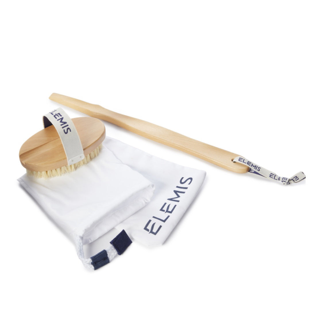 A BODY DETOX SKIN BRUSH featuring natural cactus bristles and white accents is shown, accompanied by a matching detachable handle. Both the brush and handle are branded with the name &quot;ELEMIS - STEINER.&quot; The set is displayed on a white background alongside a white bag also labeled &quot;ELEMIS,&quot; making it ideal for dry brushing.