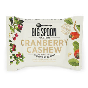 A package of BIG SPOON ROASTERS Cranberry Cashew Snack Bar. The packaging displays cranberries, cashews, and cocoa nibs against a white background, with text indicating it is gluten-free, dairy-free, soy-free, and palm oil-free and weighs 60 grams (2.1 oz).