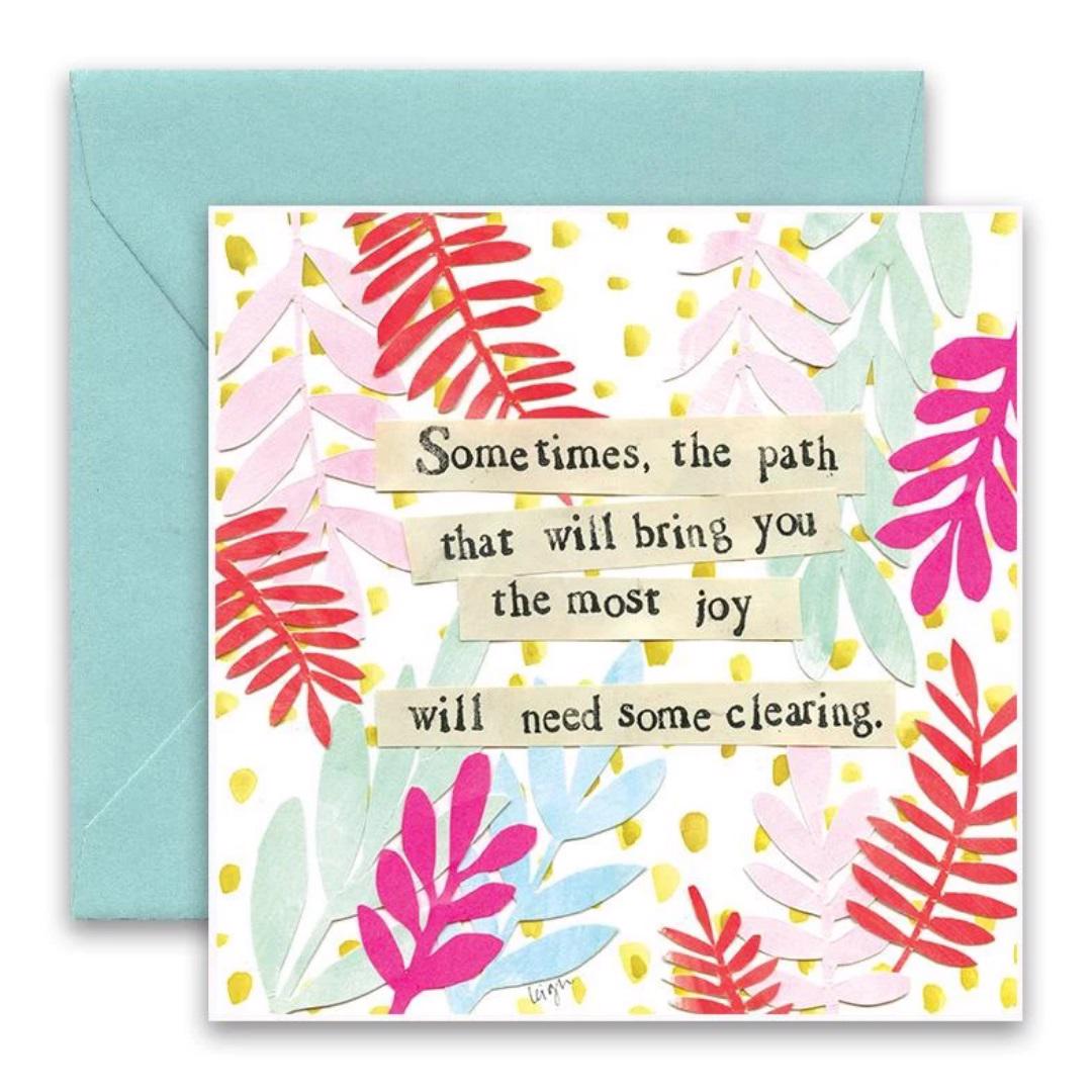 The CURLY GIRL DESIGNS - NEEDS CLEARING GREETING CARD by Curly Girl Design, Inc. showcases vibrant collage art with red, pink, and blue leaf illustrations set against a yellow-dotted backdrop. It features the message, "Sometimes, the path that will bring you the most joy will need some clearing," and comes with a light blue envelope.