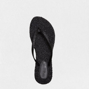 The ILSE JACOBSEN - CHEERFUL FLIP FLOP IN BLACK from Lines of Denmark features textured air rubber soles and simple thong-style straps, set against a plain white background. These flip-flops offer a comfortable fit with their casual, minimalist design.