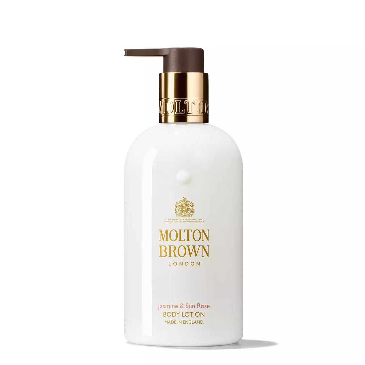 A MOLTON BROWN - JASMINE AND SUN ROSE BODY LOTION comes in a white bottle with a brown pump and gold collar. The delightful floral scent of jasmine and Sun Rose is marked by the "Molton Brown London" text in gold lettering, along with "Jasmine &amp; Sun Rose Body Lotion Made in England" printed in a smaller font.