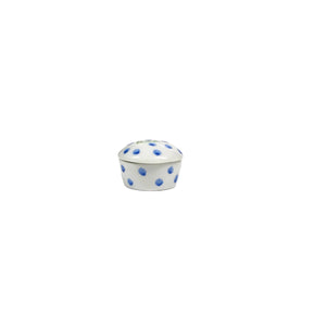 A bespoke, small round porcelain keepsake by ANN MARIE MURRAY, L.L.C., featuring blue polka dots and green cursive text "FIRST LOCK" meticulously hand-painted in the center.