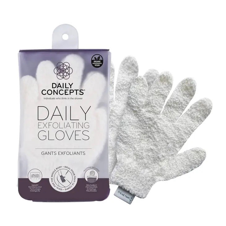 Packaging of DAILY CONCEPTS EXFOLIATING GLOVES next to one pair of white exfoliating gloves. The packaging features a purple and white design with product information, including &quot;Individuals who think in the shower,&quot; an &quot;organic cotton&quot; icon, and tips for use as a Pre Self-Tanning Ritual.