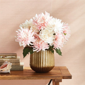 A life-like pink chrysanthemum by Napa Home and Garden blooms on a slender green stem with leaves, set against a white backdrop.