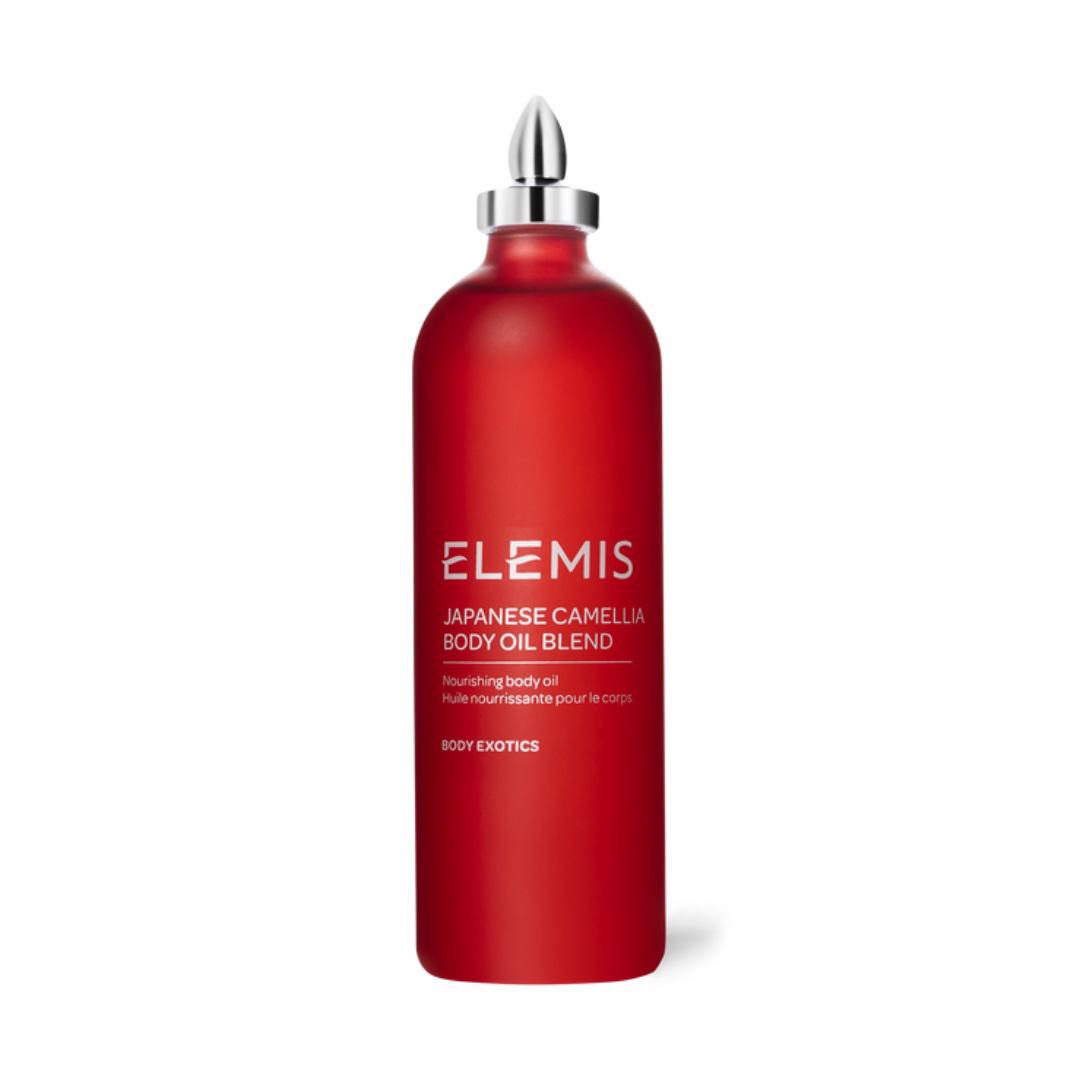 A sleek red bottle of ELEMIS - JAPANESE CAMELIA OIL BLEND by ELEMIS - STEINER, adorned with a metallic silver cap. The bottle features white text displaying the product name and description, promoting it as a luxurious body oil that moisturizes and softens skin, ideal for preventing pregnancy stretch marks.