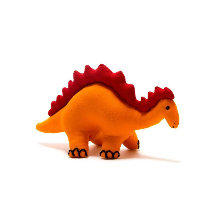 A COTTON STEGOSAURUS DINOSAUR plush toy by BEST YEARS LTD, featuring a handmade design with an orange body and red spines along its back, stands against a white background. The stuffed toy also includes black detailing on its feet and face.