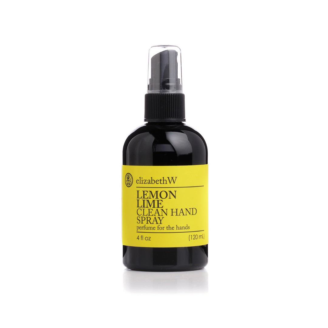 A 120 ml bottle of E Wightman &amp; Co LEMON LIME HAND SPRAY 4OZ is shown. The black bottle with a yellow label states the product name and description: "perfume for the hands." Featuring a black spray nozzle, it contains 4 fl oz of liquid and doubles as a travel size hand sanitizer.