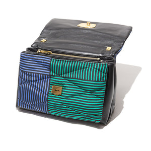 The MILANO MM33 VINTAGE SCARF AND LEATHER HANDBAG - GEOMETRIC TILE is a stylish lambskin accessory adorned with a quilted, multicolored stripe pattern in black, white, blue, and green. It features a gold buckle on the front flap and a matching gold chain strap, all beautifully displayed against a white background. MADE IN ITALY.