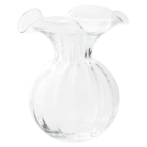 The VIETRI - HIBISCUS LARGE VASE CLEAR showcases a clear glass design meticulously crafted by skilled Tuscan artisans. It features a round, bulbous body and a wide, ruffled rim, exuding smooth elegance that is perfect for displaying a fresh bouquet or looks equally stunning on its own.