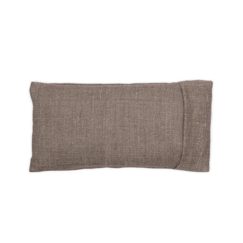 The LINEN - NATURAL EYE PILLOW by E WIGHTMAN &amp; CO is a rectangular, light brown fabric pouch with a subtle woven texture, displayed against a plain white background. The pouch features a flap on one side, indicating it can be opened—ideal for holding an eye pillow filled with calming lavender and flaxseed. Suitable for containing small items.