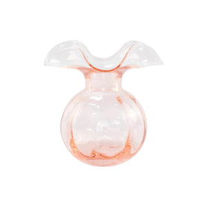 The VIETRI Hibiscus Bud Vase Pink features clear glass with a pale pink tint and a wide, wavy flared rim, inspired by Tuscan artisan craftsmanship and Hibiscus glass designs. Set against a white background.