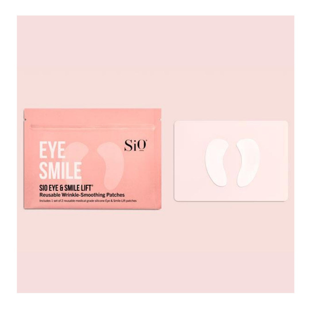 The image shows a product package labeled &quot;SIO EYE AND SMILE&quot; by SIO BEAUTY. The package contains &quot;SIO Eye &amp; Smile Lift Reusable Wrinkle-Smoothing Patches.&quot; Made from medical-grade silicone, these patches target fine lines and wrinkles around the eyes and laugh lines. Next to the package, two white, crescent-shaped patches are displayed on a light pink background.