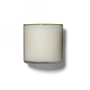 The LAFCO - FEU DE BOIS, SKI HOUSE 6.5OZ by LAFCO is a white, cylindrical candle encased in a clear glass holder with a slightly green-tinted top edge. Infused with soothing scents of frankincense and sandalwood, it casts a soft shadow to the right on a white background.