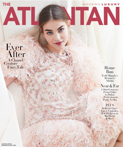 A woman with long, dark hair reclines in a fluffy, embellished pink dress on the cover of The Atlantan magazine. The headline reads "Ever After: A Chanel Couture Fairy Tale." Additional text highlights features like Todd Murphy's return to Atlanta and luxury getaways. Fearrington Village