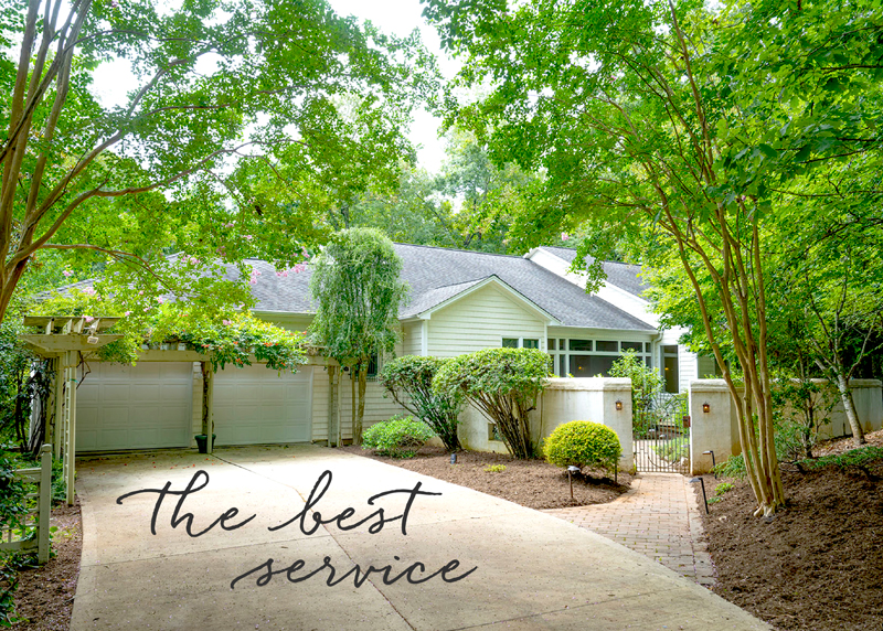 A charming house with a white exterior and a well-maintained front yard, surrounded by lush greenery and trees. A long driveway leads to the garage, and the text "the best service" is overlaid at the bottom of the image. Fearrington Village