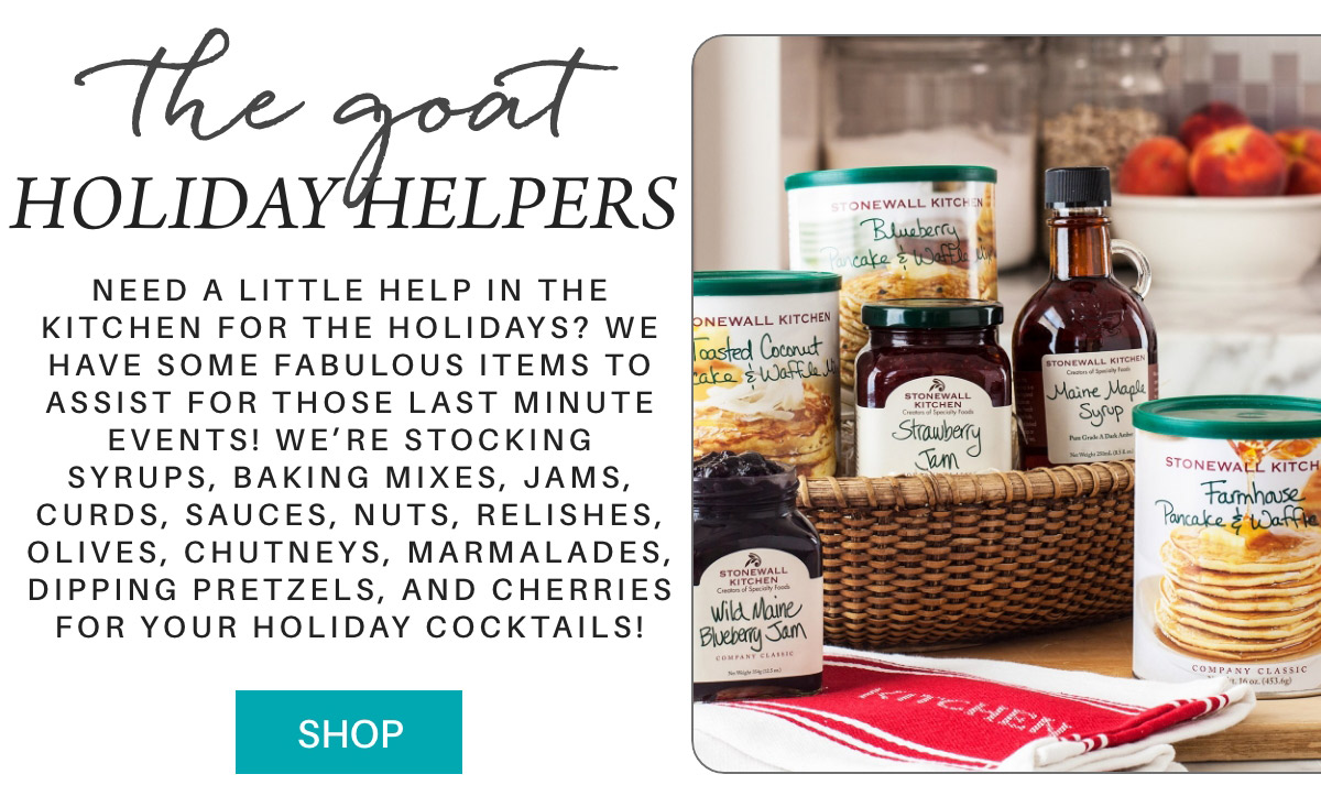 A collection of Stonewall Kitchen products including jams, syrup, sauces, and baking mixes displayed on a table. The text highlights holiday helpers for last-minute events, featuring items like chutneys and cherries for cocktails. A "Shop" button is visible. Fearrington Village