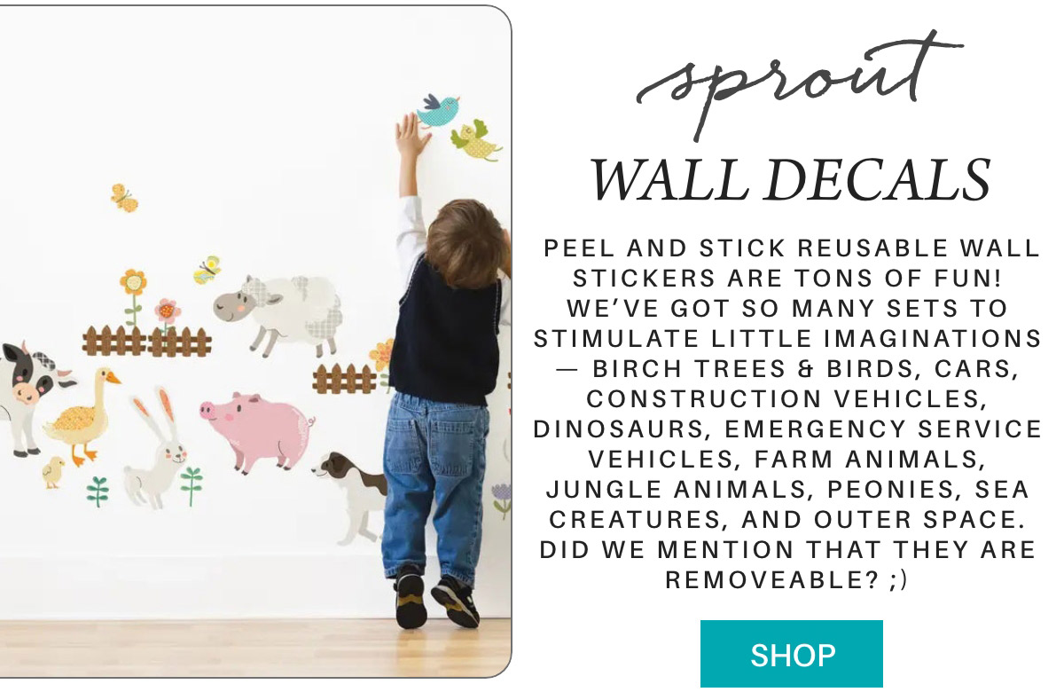 A child reaches up to place a wall decal on a white wall covered with various animal and nature-themed decals. Text on the right reads "Sprout Wall Decals" with a detailed description of the product, emphasizing their reusability, variety, and ease of use. A blue "SHOP" button is below. Fearrington Village