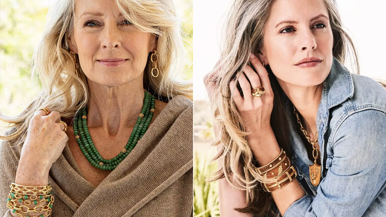 Two women are pictured wearing jewelry. The woman on the left has long blonde hair, wears layered gold bracelets, drop earrings, a green bead necklace, and a beige top. The woman on the right has wavy blonde hair, wears chunky gold rings, bracelets, earrings, and a denim shirt. Both are posing confidently. Fearrington Village