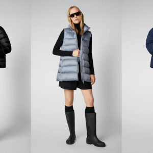 Three models in different winter outfits. The first wears a black puffer jacket and matching pants. The second is in a light grey puffer vest with black skirt, top, and tall boots. The third sports a dark blue puffer jacket, black bucket hat, skirt, and tall boots. Fearrington Village