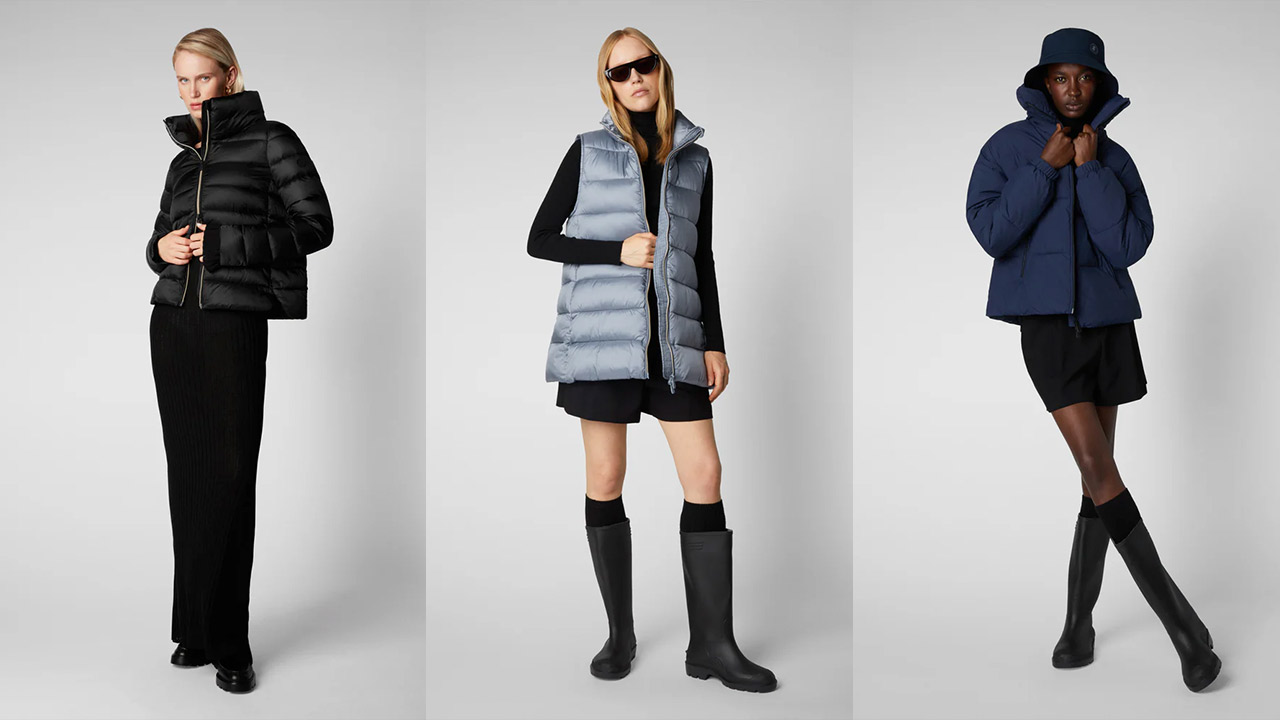 Three models in different winter outfits. The first wears a black puffer jacket and matching pants. The second is in a light grey puffer vest with black skirt, top, and tall boots. The third sports a dark blue puffer jacket, black bucket hat, skirt, and tall boots. Fearrington Village