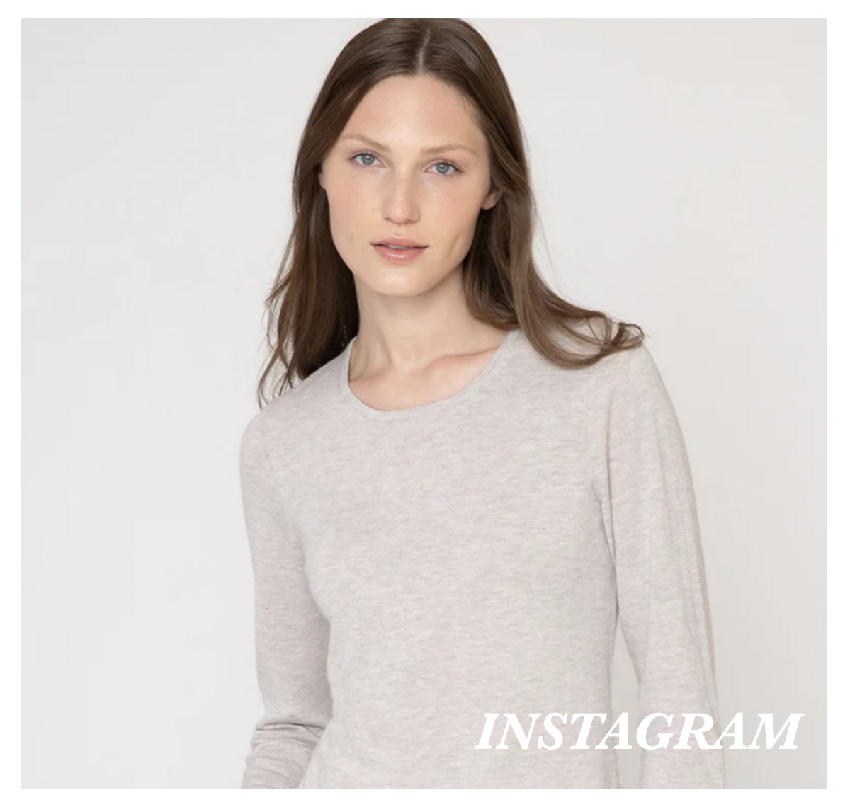A woman with long brown hair wearing a light gray, long-sleeve shirt stands against a plain background. She has a neutral expression. The word "INSTAGRAM" is written in white in the bottom right corner. Fearrington Village