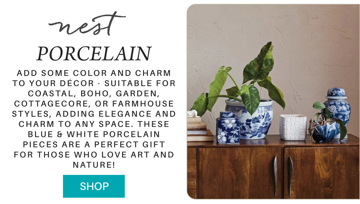 A wooden cabinet holds blue and white porcelain pieces, including vases and jars, complemented by a green leafy plant. The text reads: "NEST PORCELAIN. Add some color and charm to your décor... These blue & white porcelain pieces are a perfect gift for those who love art and nature!" A "SHOP" button is at the bottom. Fearrington Village