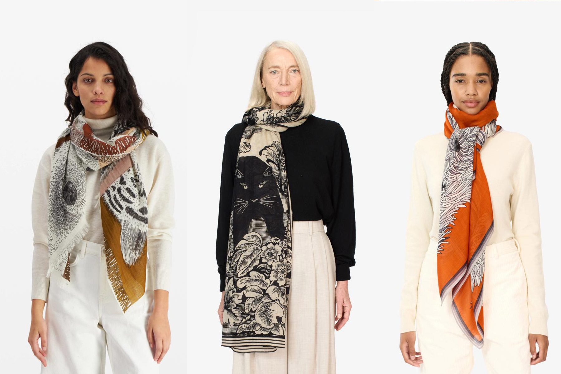 Inoui Editions. Three women are shown wearing stylish scarves. The woman on the left wears a white sweater with a multi-colored scarf. The woman in the center sports a black top with a patterned scarf. The woman on the right has a cream top with an orange scarf. Fearrington Village