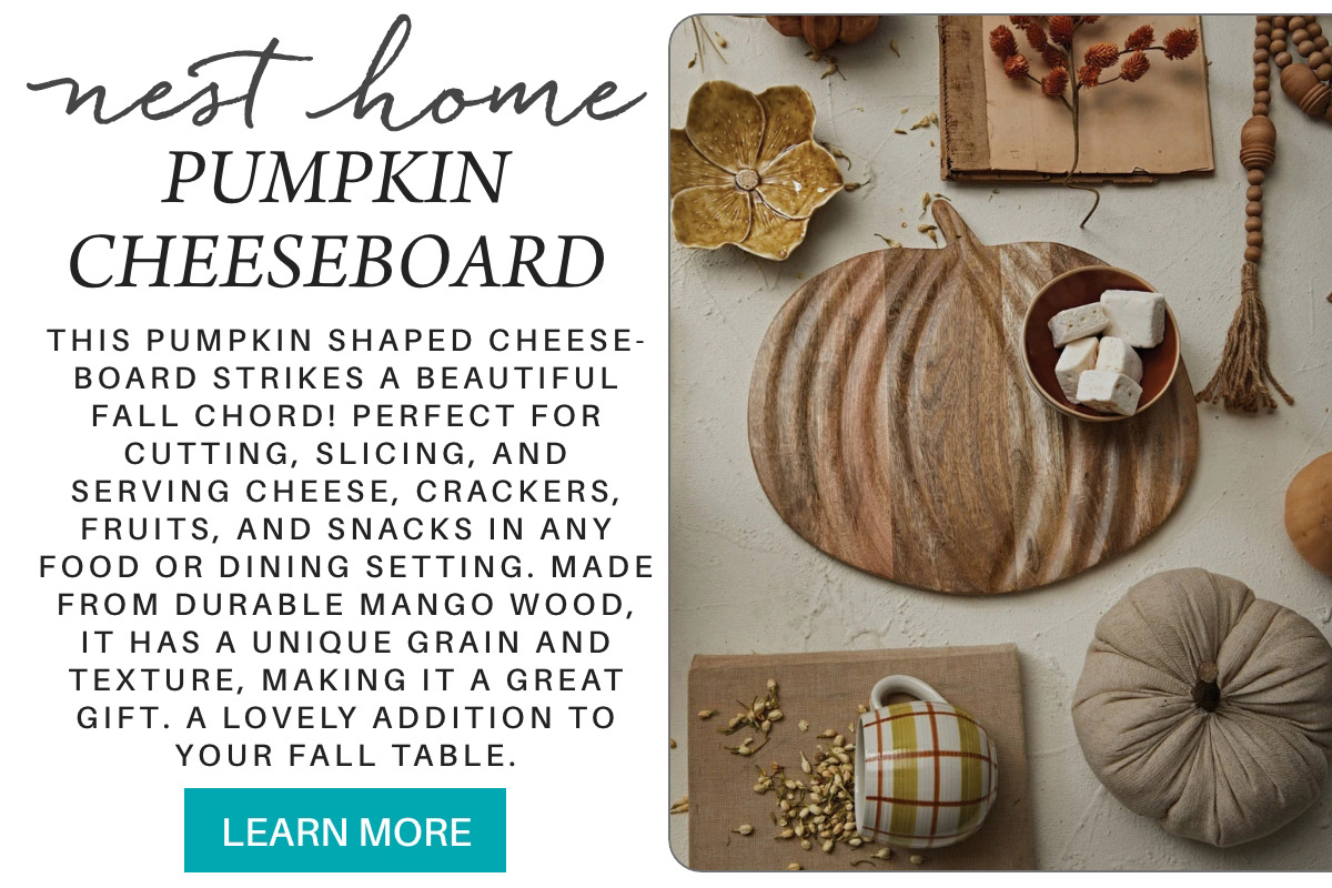 A rustic autumn-themed ad featuring a pumpkin-shaped cheeseboard with cheese and crackers. Surrounding items include leaves, a quilted pumpkin decor, and nuts. Text highlights features of the cheeseboard and invites viewers to learn more. Fearrington Village