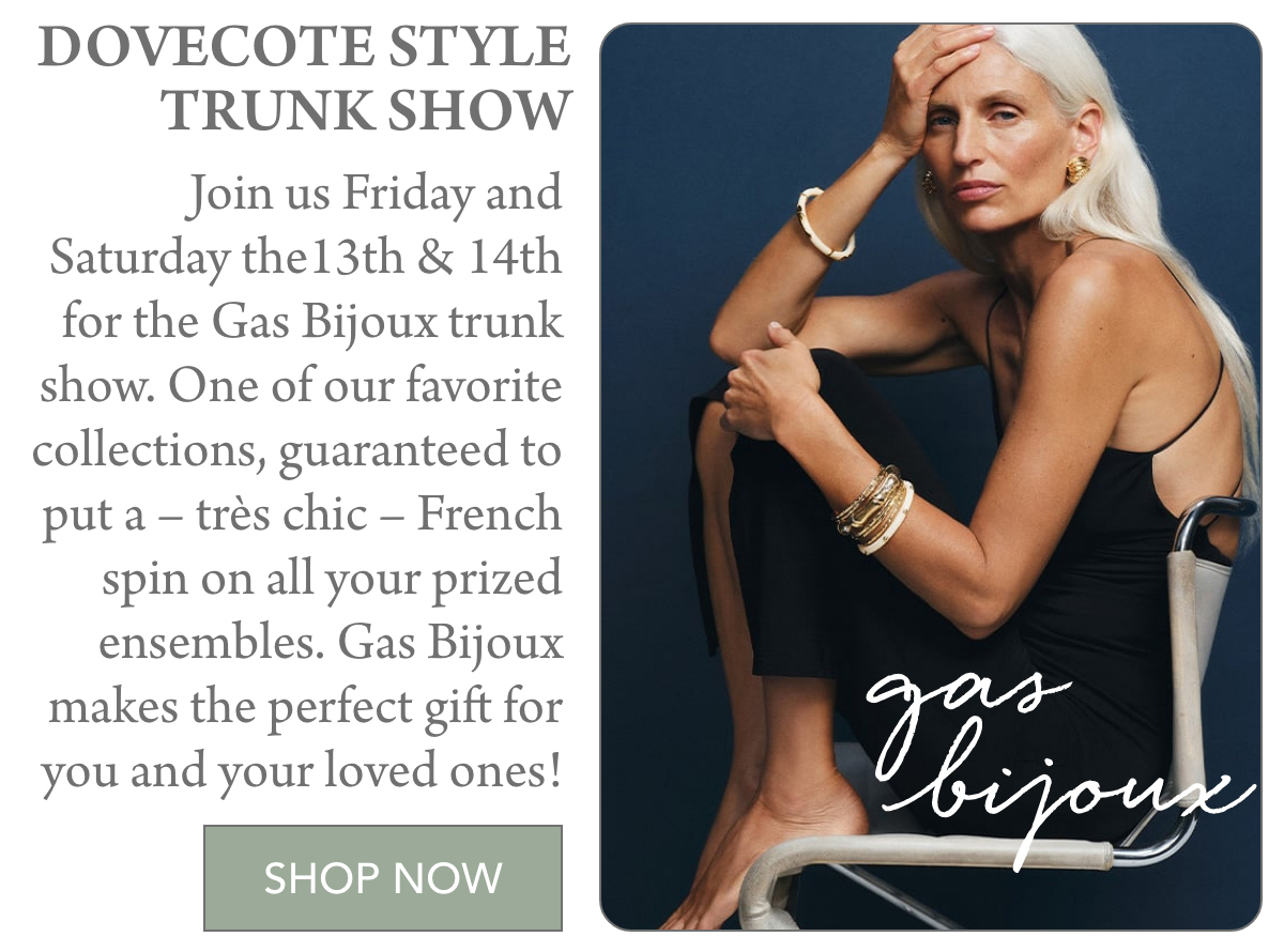 Elegant woman sitting in a chair, wearing black attire and gold jewelry. Text details a trunk show for Gas Bijoux on Friday the 13th and 14th. It highlights French chic collections and invites shopping with a "Shop Now" button. Fearrington Village