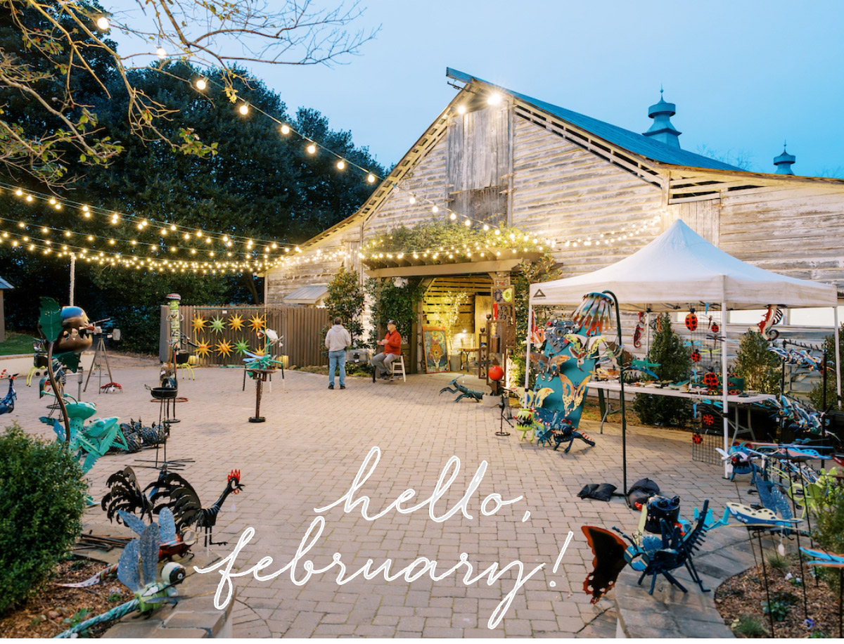 A rustic barn decorated with string lights hosts an outdoor market at dusk. Decorative metal sculptures are displayed outside. The words "hello, february!" are written across the image in elegant script. Fearrington Village