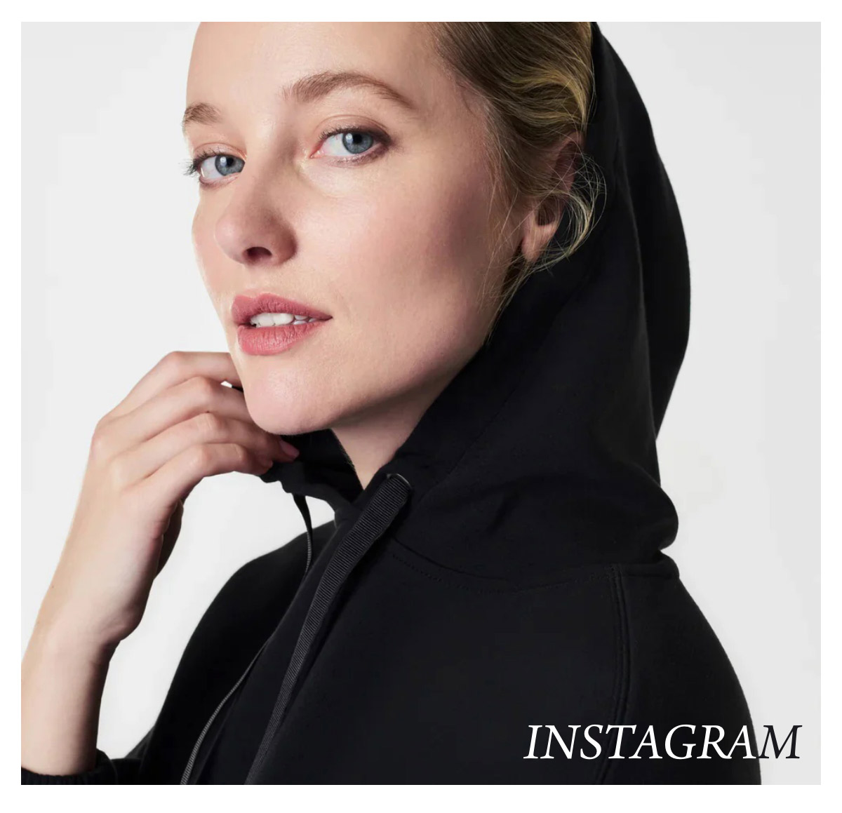 A person with blond hair gazes at the camera while wearing a black hoodie. The word "Instagram" is positioned in the bottom right corner. The background is a simple, light color. Fearrington Village