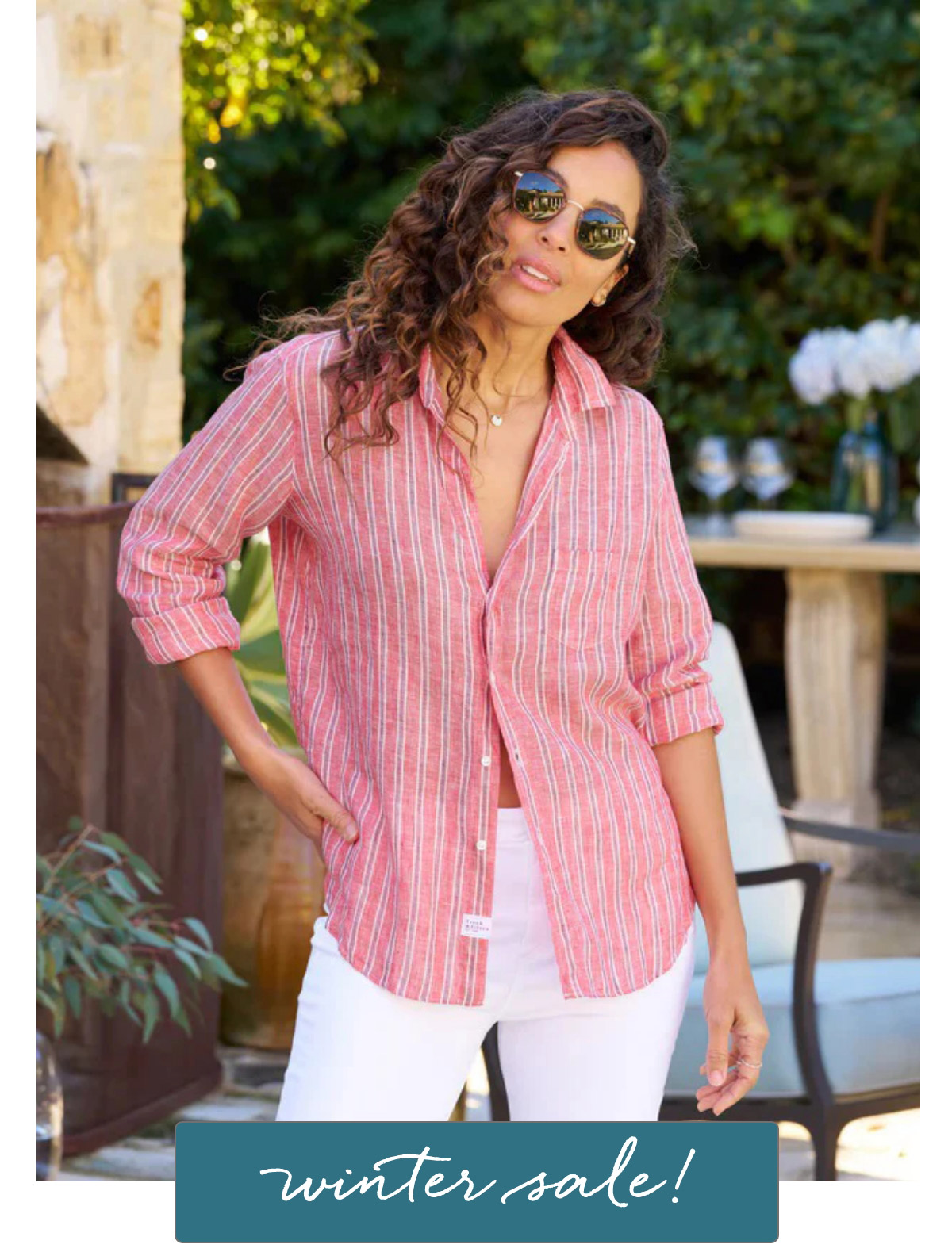 A woman wearing sunglasses and a red and white striped shirt stands outdoors, posing casually. She is in front of a table and greenery. Text at the bottom of the image reads, "winter sale!. Fearrington Village