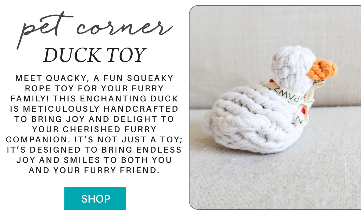 The image shows an advertisement for a duck-shaped rope toy for pets. The toy is white with an orange beak. Text highlights its handcrafted design and joyful purpose for pets. A button labeled "Shop" is at the bottom. Fearrington Village