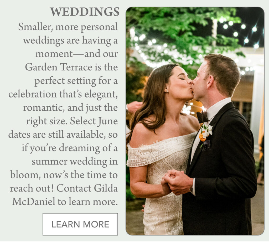 A bride and groom share a kiss while dancing outdoors under string lights, surrounded by greenery. Text promotes intimate summer weddings on a garden terrace and invites readers to contact Gilda McDaniel to learn more. "Smaller, more personal weddings are having a moment—and our Garden Terrace is the perfect setting for a celebration that’s elegant, romantic, and just the right size. Select June dates are still available, so if you’re dreaming of a summer wedding in bloom, now’s the time to reach out! Contact Gilda McDaniel to learn more." Fearrington Village